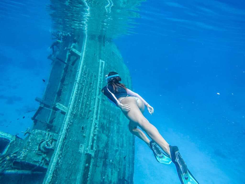 How much does a trip to the Maldives cost in 2021 - Girl snorkeling around a shipwreck